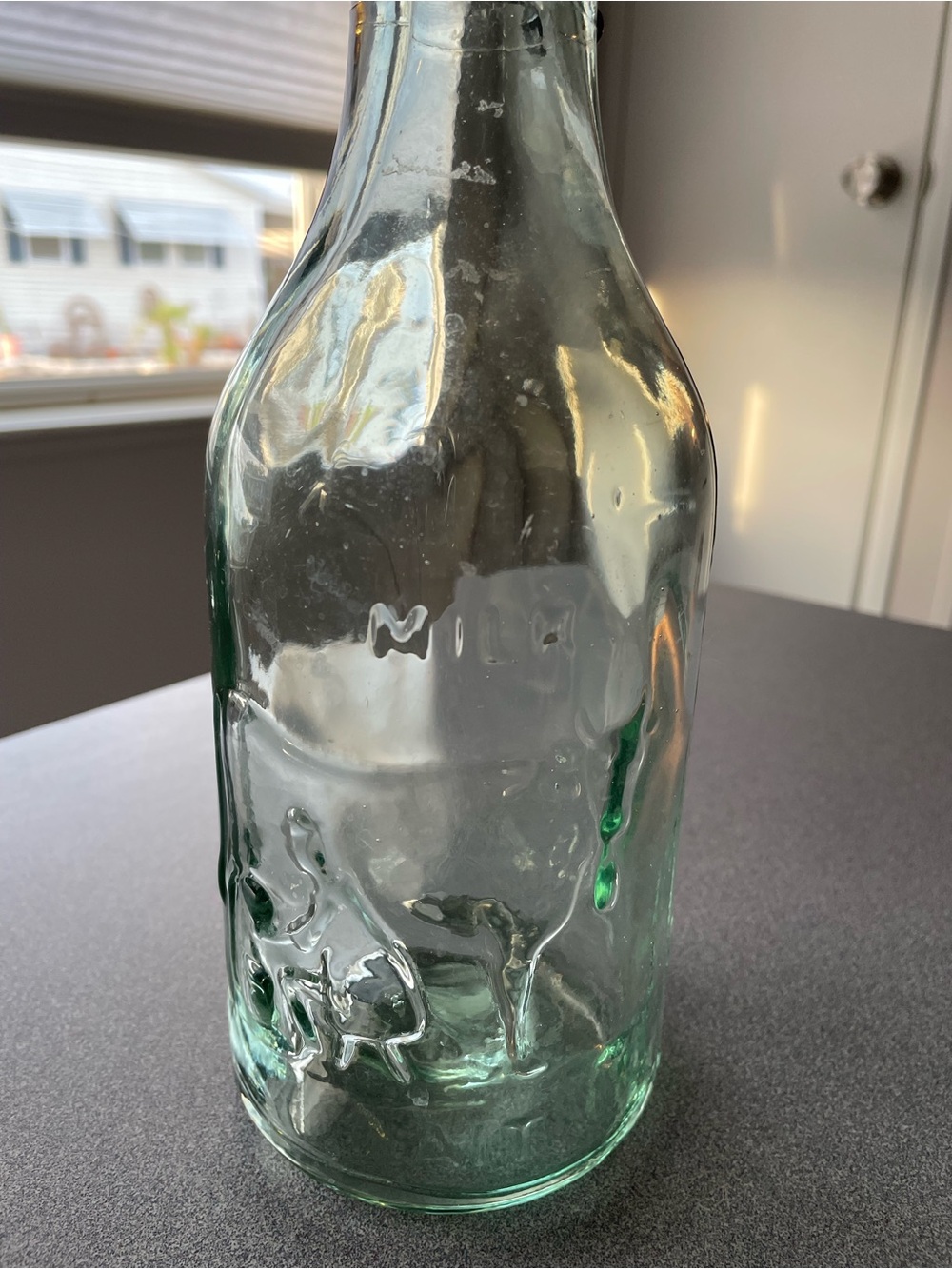 Vintage Milk Aqua Glass Swing-Top Bottle with farmer milking cow